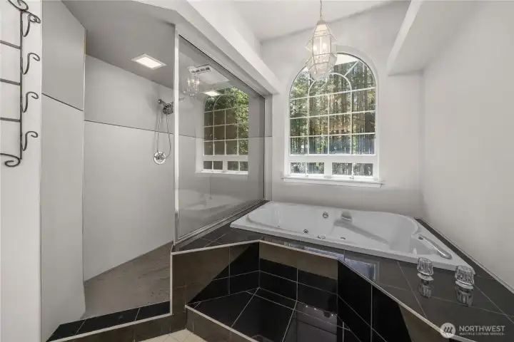 Jetted tub and large walk-in shower in primary bath. Jetted tub and large walk-in shower in primary bath.