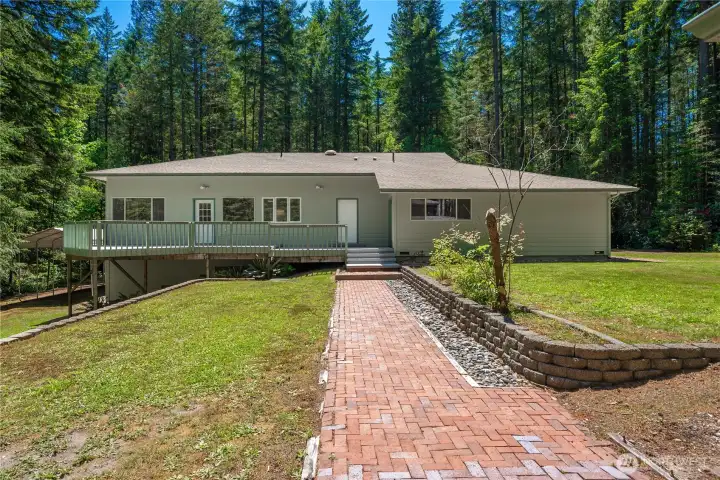 View toward the back of the house with the spacious deck. Bright and sunny here but surrounded by your own trees for maximum privacy. View toward the back of the house with the spacious deck. Bright and sunny here but surrounded by your own trees for maximum privacy.