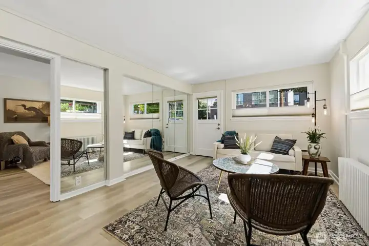 Large living room bathed in natural light. Luxury Vinyl Plank flooring throughout.