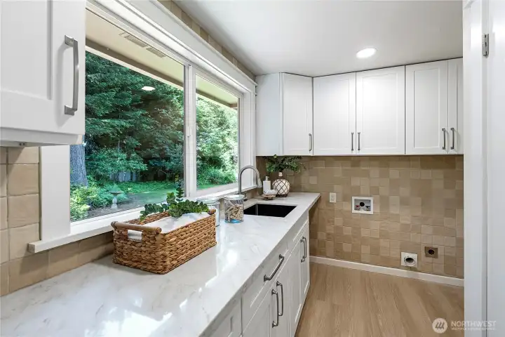 Huge laundry room with sink, storage and quartz countertops