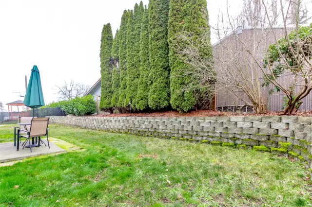 Owner added the garden bed wall in the back yard