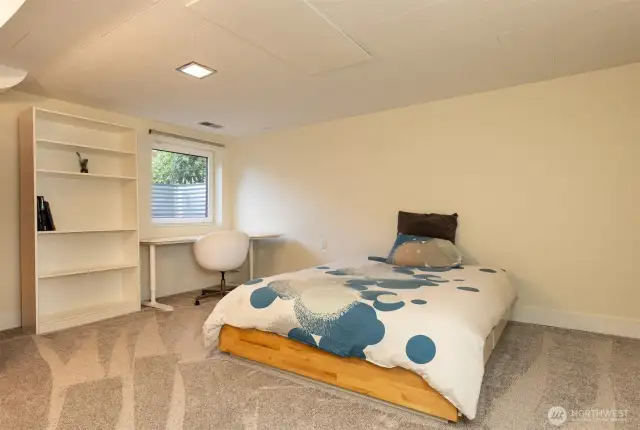 The larger of two lower floor bedrooms, with custom closet, radiant ceiling heat, and extra storage.