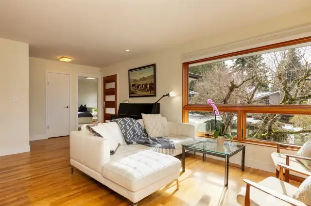 Light-drenched living room with views from the couch and the attached balcony.