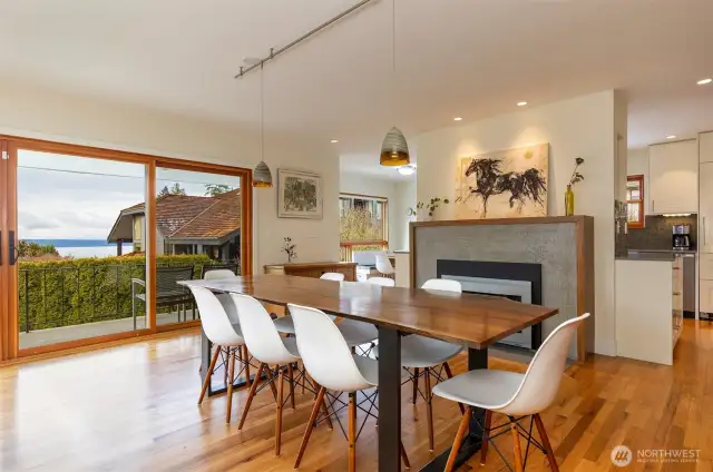 Open living/dining area with views and beautiful custom fireplace.