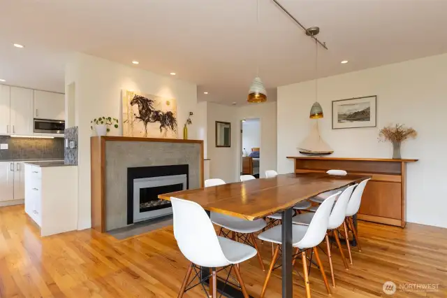 Open living/dining area with views and beautiful custom fireplace.