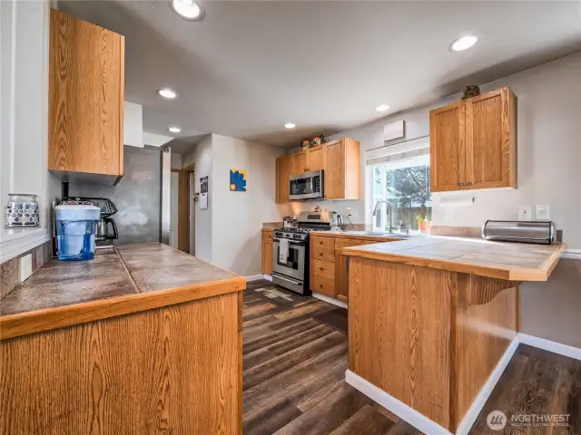 Spacious kitchen with tile counters & eating space