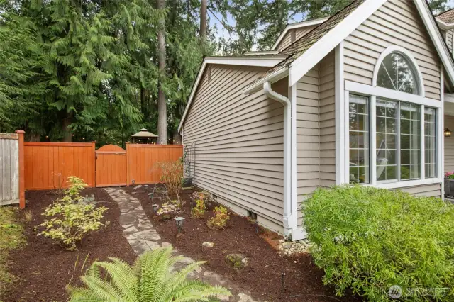 Beautiful, professionally landscaped yard with pavers and plantings.