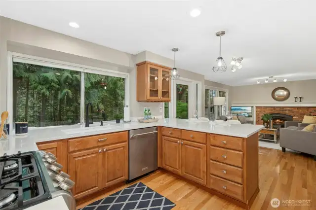 The kitchen is adorned with sleek quartz countertops and stylish stainless steel appliances and upgraded lighting.