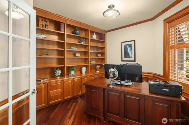 Just off the foyer is this expansive office with built-in library shelving--ideal for remote work!
