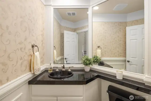 Main floor powder room with granite countertops.