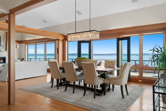 Dining room french doors open to a massive waterside view deck that runs the entire length of the home.