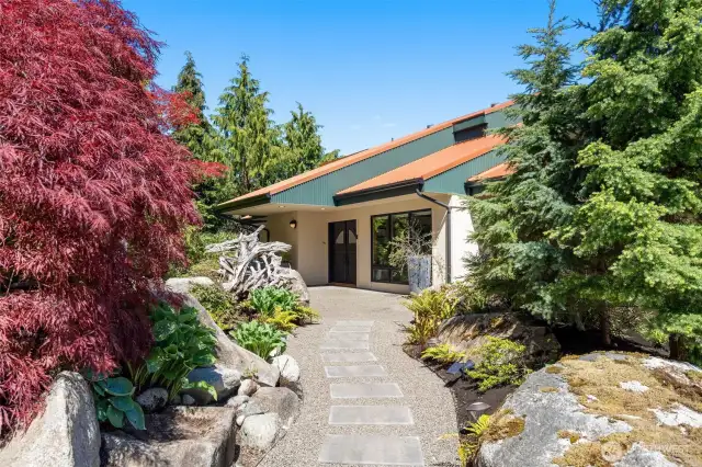 Gorgeous, lush landscaping... enticing approach to front door sets the stage for what's next.