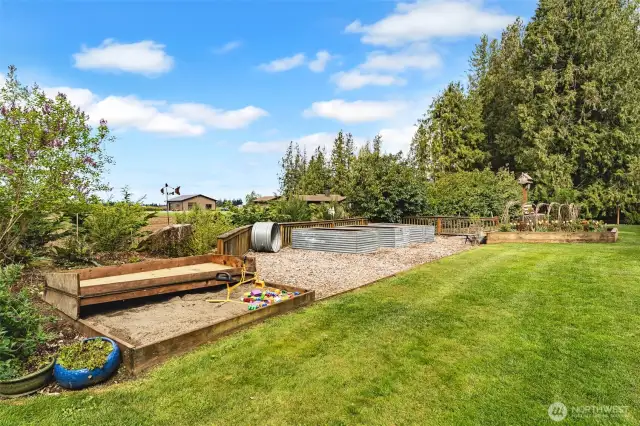 Hidden sand box and raised garden beds