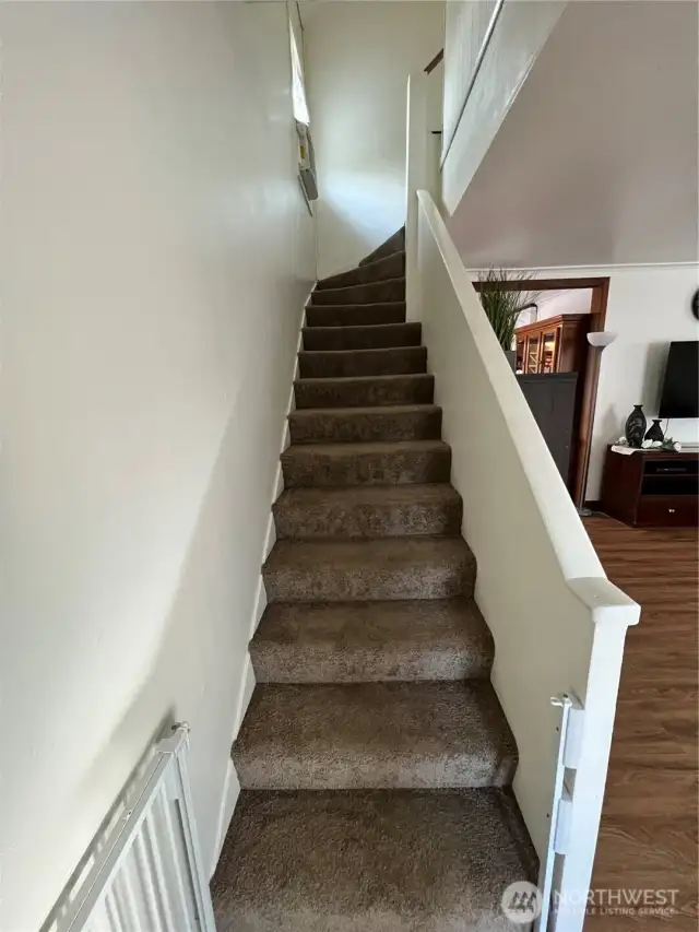 Stairway up to 3 bedrooms.
