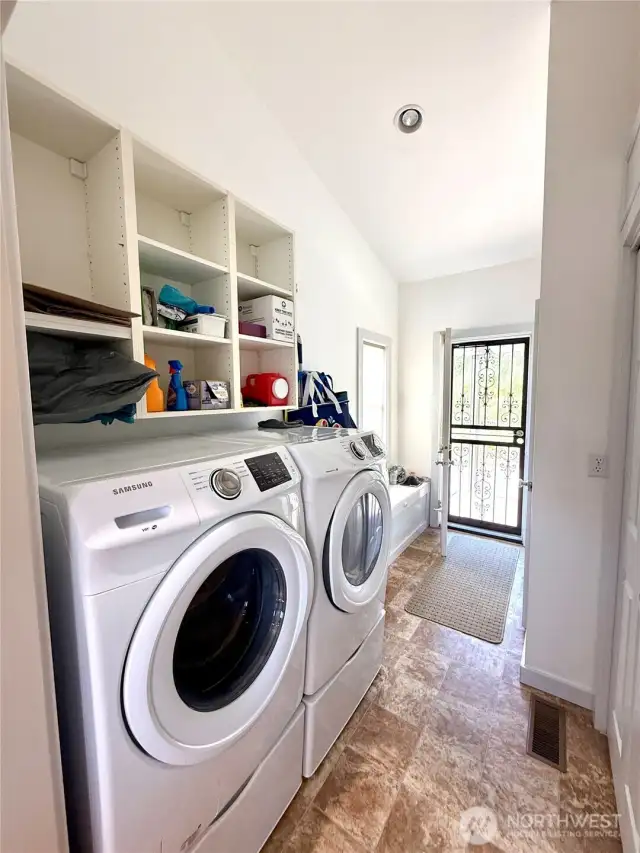 Laundry Room with Attached 1/2 Bath. Direct Access to the Outside.