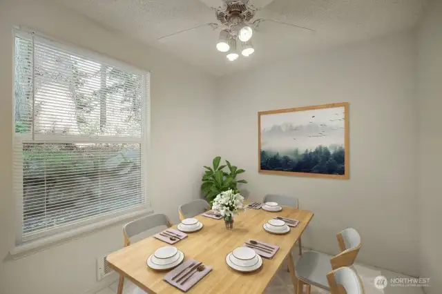 The dining area has lots of light from the large windows.