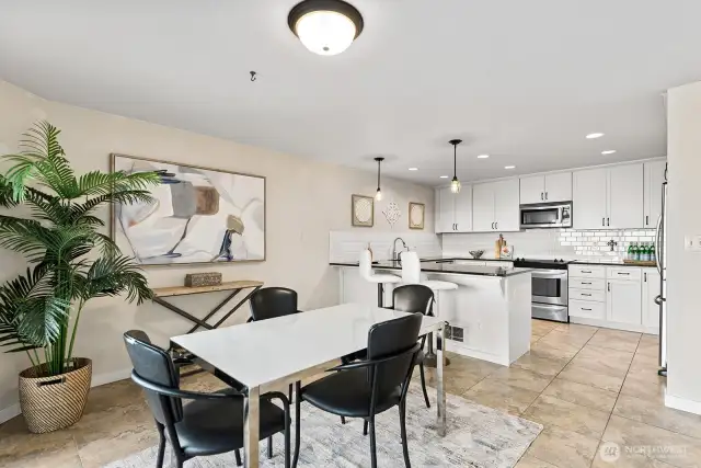 This open kitchen is so functional! Loads of storage, stone counters, great lighting, beautifully designed and built.