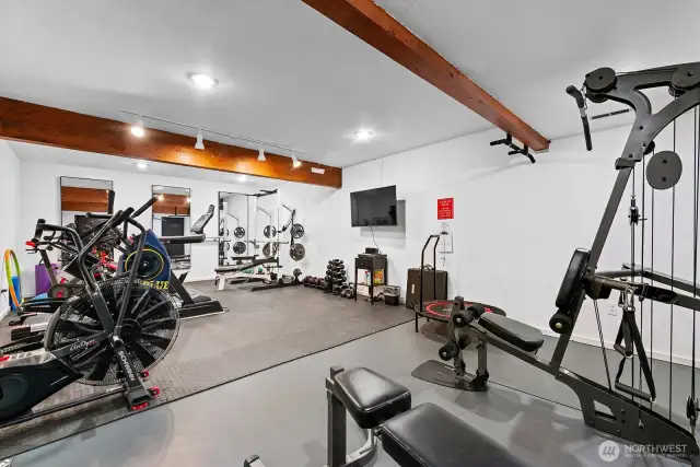 Well equipped exercise room in the lower level of the cabana.
