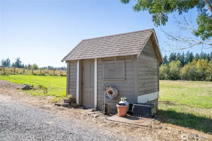 Near the front of the property and the home is this little outbuilding.