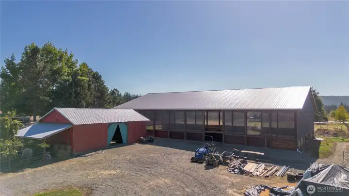 Up the driveway that is gated.  Here is the tackroom shop with hayshed to the left.  Arena built 2022 is shown here.