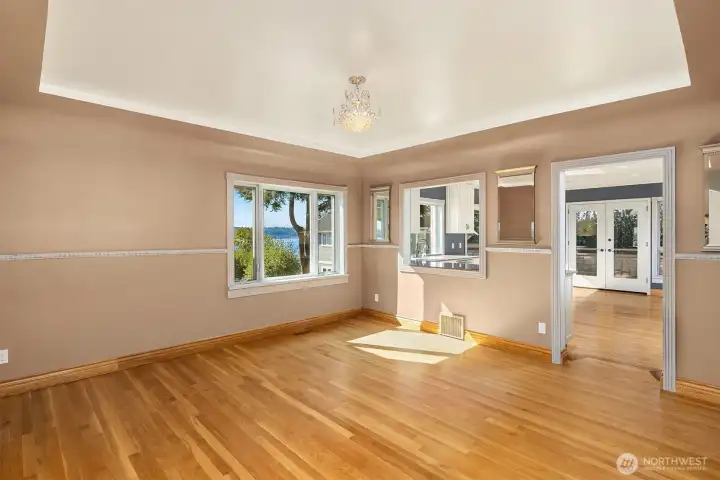 Formal dining with coved ceilings and pass through to the oversized chef's kitchen