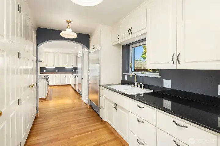 The Butlers pantry offers additional fridge space, tons of storage and a dish prep.