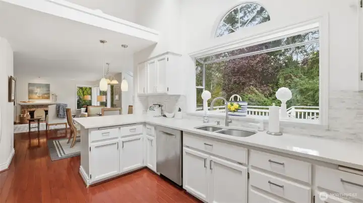 The garden window invites the pleasant private view and ample natural light.  At the end of the kitchen count is the perfect 2 spot casual eating bar.