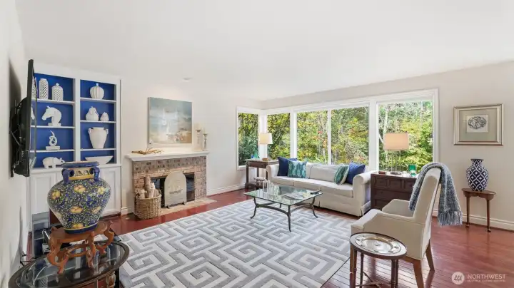 A brick surround gas log fireplace sets the warm feeling while enjoying the gorgeous private views.  There are built-in shelves and cabinets.