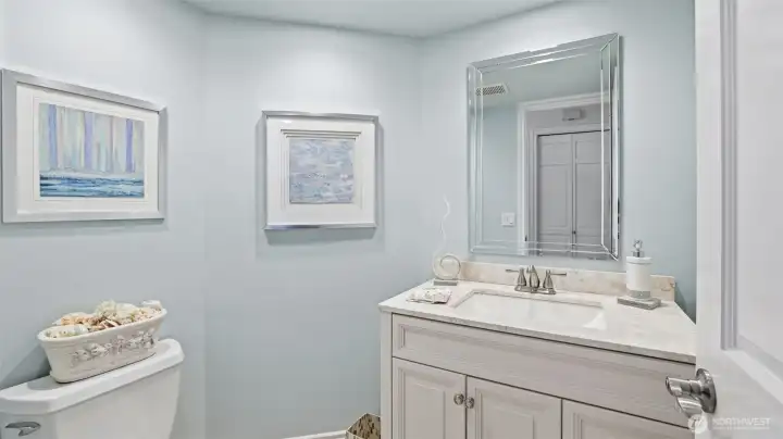 The powder room is updated with quartz counter and undermount sink.