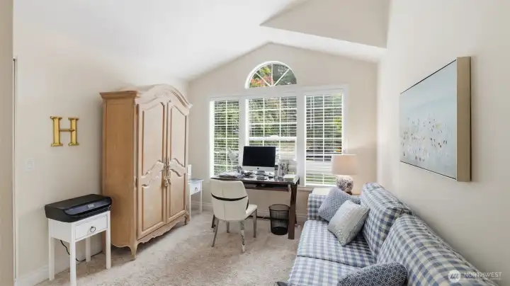 One bedroom has a peaked ceiling and a walk-in closet and custom paint.