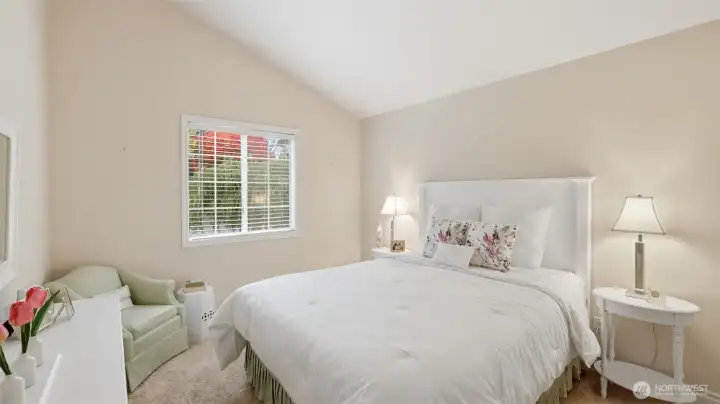 This bedroom has a vaulted ceiling and custom paint.