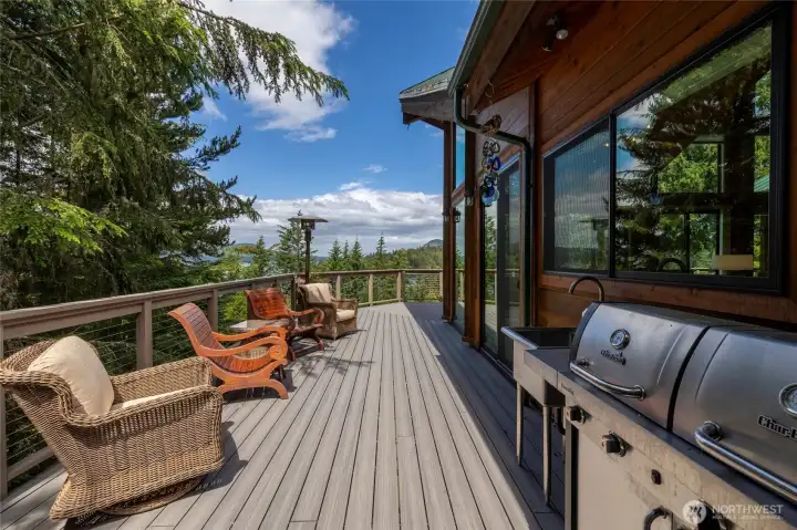 Entertainer’s deck with  grilling space and plenty of seating, ideal for long evenings, sunset dinners, and hosting guests on the island