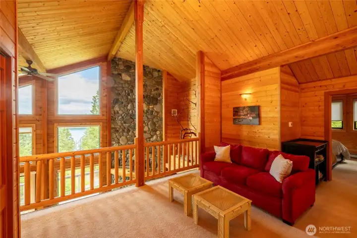 loft style upper level with two bedrooms, bath, and lounge area