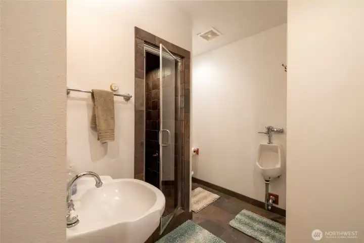 Spa-inspired bath featuring a custom cedar sauna and steam room, thoughtfully designed for post-workout recovery and daily wellness rituals