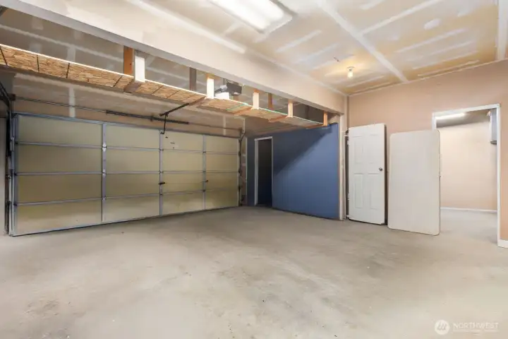 3 bay garage has 3rd bay divided into a storage room and a workshop.