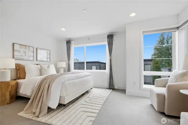 Huge primary bedroom with space for a sitting area/work area and big windows