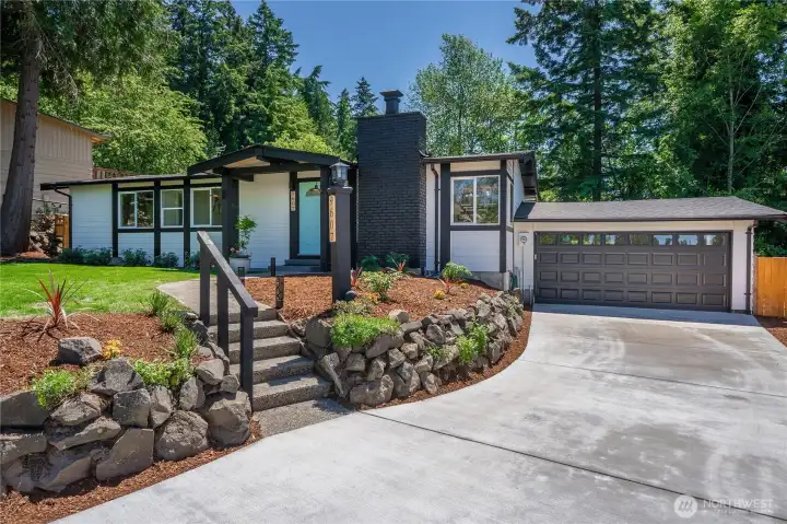 Abundant parking, no HOA, RV space, lush landscaping, extended drive and large two car garage.