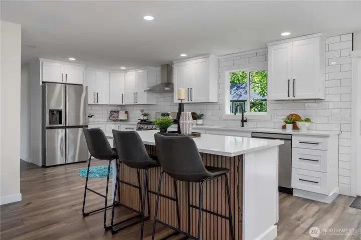 Abundant cabinet and counter space, Chefs island with power, Brand-new appliances.  Light, bright and spacious kitchen open to family room