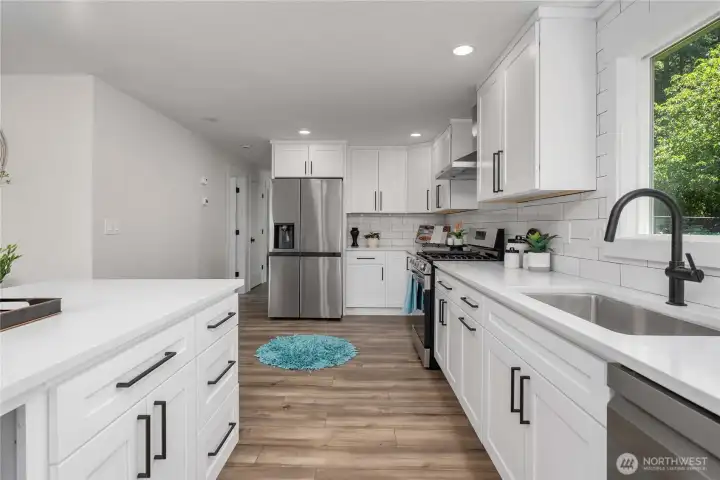 Linear lighting accents, expansive tile backsplash quality hardware.  Great gathering space