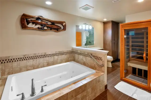 A full bath and sauna off the lower level rec room includes a spacious shower and large jetted tub.