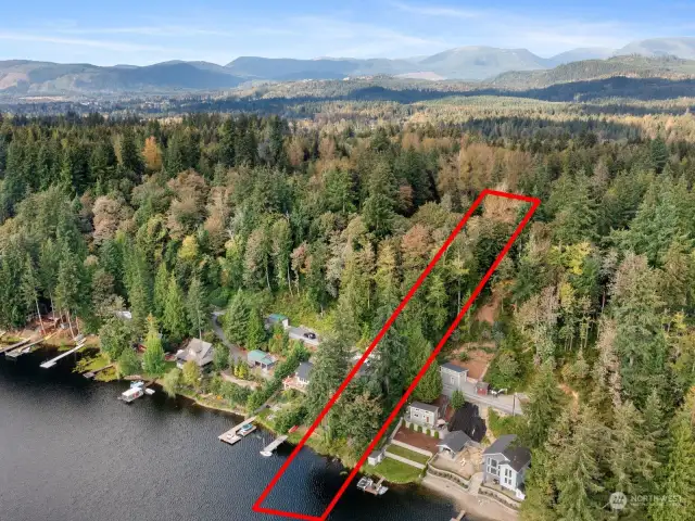 The lot is spit by the road, house plans are up top. the road then the bottom property leading to the lake