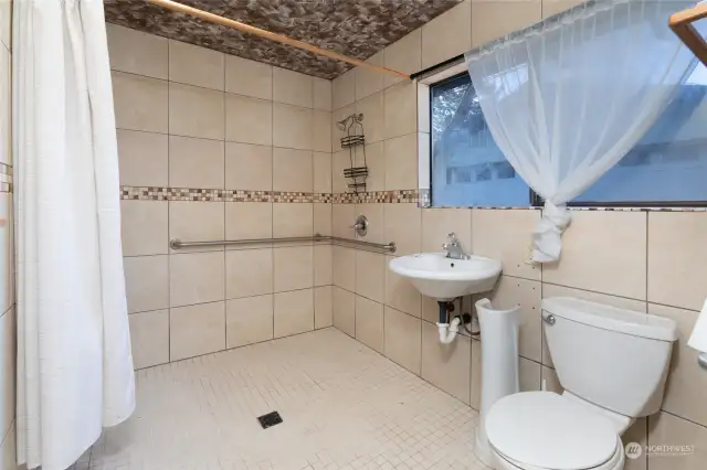 3/4 bathroom in the South wing with roll in shower & grab bars in shower and by toilet.