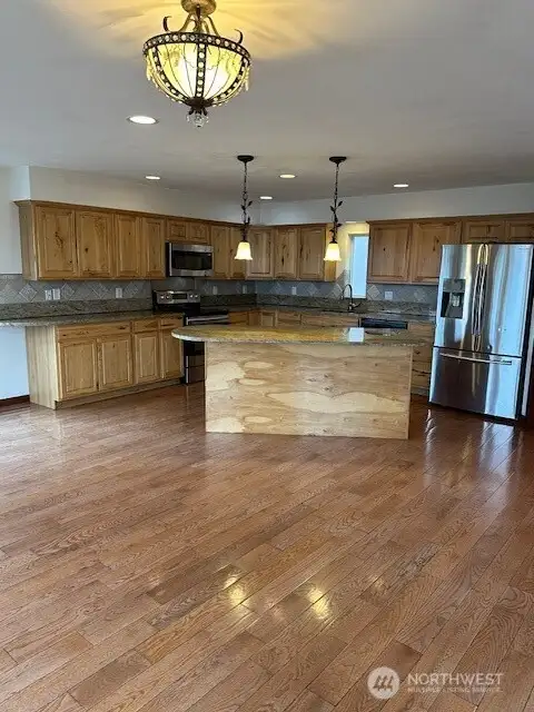 The kitchen adjoins the living room area with extensive view and high end quality cabinets and counter top