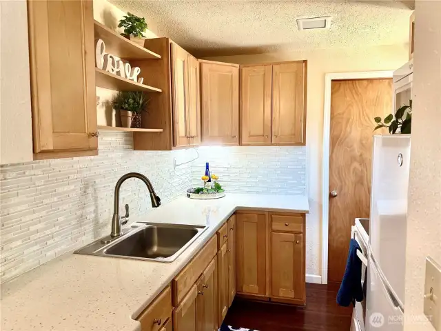 Updated kitchen w/backsplash and Corian countertops