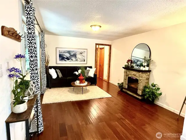 Lovely open living room w/ electric fireplace