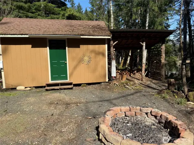 Large storage shed w/ extra shelving and electricity.