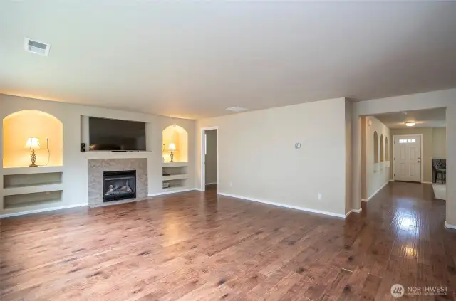 This wide-angle look captures both the family room and front entry, highlighting the spacious design.