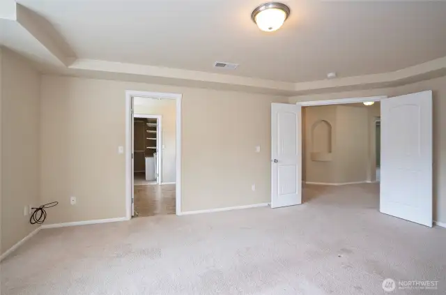 From the primary suite, enjoy a graceful view through elegant double doors that open to a bright and airy upper landing—adding a sense of openness and sophistication to the space.