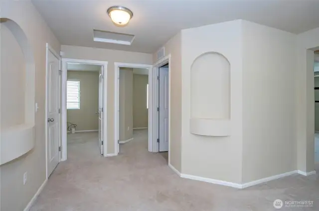 Spacious upper-level landing connects to three private guest bedrooms.