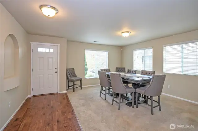 Step into a light and bright living space, currently used by the seller as a dining area.